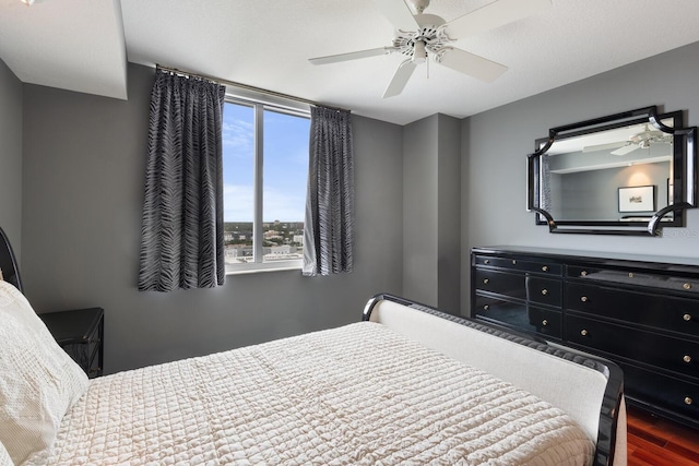 bedroom featuring ceiling fan and hardwood / wood-style flooring