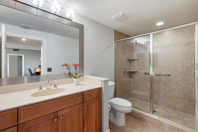 bathroom with vanity, toilet, an enclosed shower, a textured ceiling, and tile patterned flooring