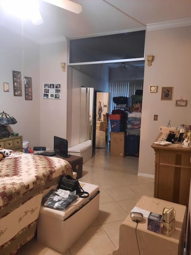 bedroom featuring ceiling fan, light tile patterned floors, and crown molding