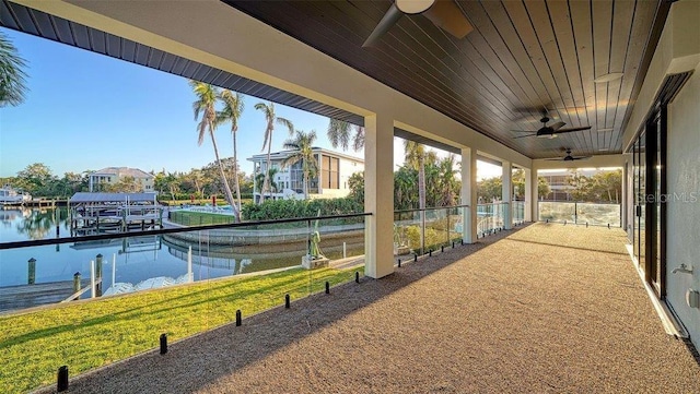 exterior space featuring a water view, ceiling fan, and a boat dock