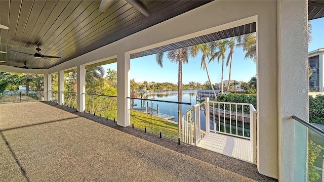 view of patio with ceiling fan and a water view