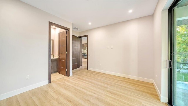 empty room with light hardwood / wood-style floors