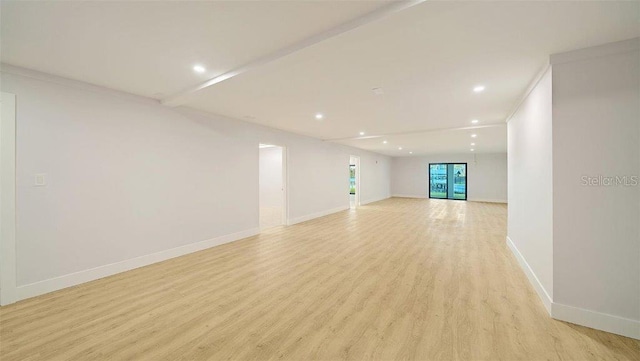 spare room featuring light hardwood / wood-style floors and crown molding