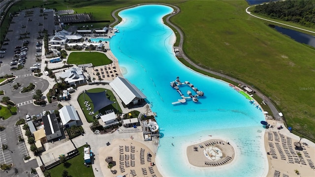 drone / aerial view featuring a water view and a beach view