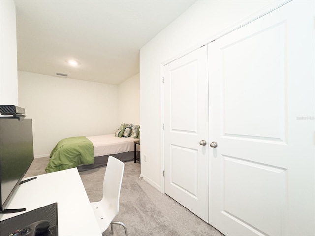 carpeted bedroom featuring a closet