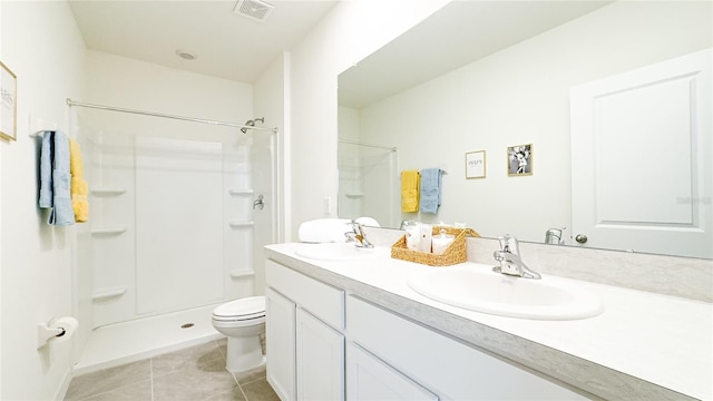 bathroom featuring toilet, walk in shower, vanity, and tile patterned floors