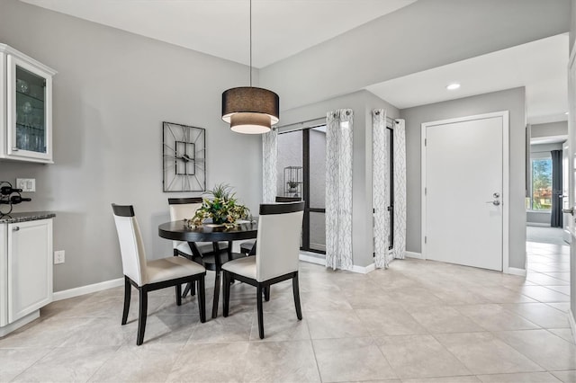dining area with baseboards, recessed lighting, and light tile patterned flooring