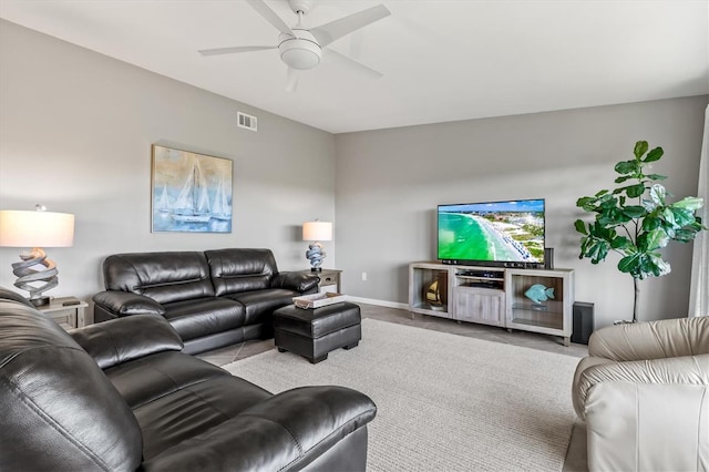 living room with a ceiling fan, baseboards, visible vents, and tile patterned flooring