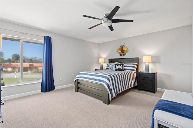 bedroom featuring baseboards, light carpet, and ceiling fan
