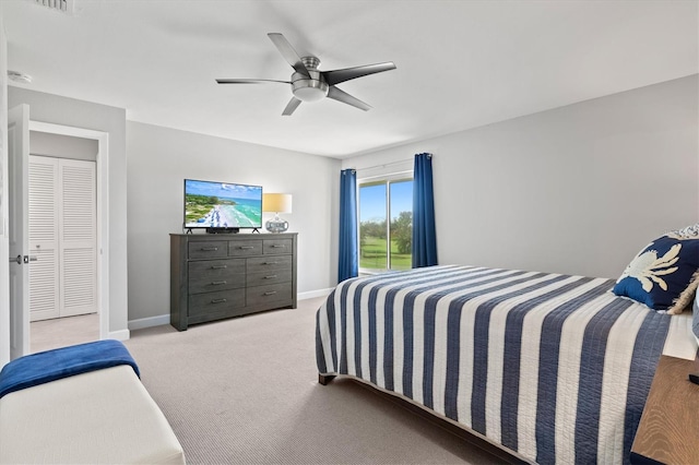 bedroom featuring light colored carpet and ceiling fan