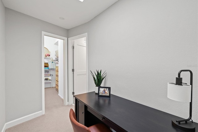 office space featuring baseboards and light carpet