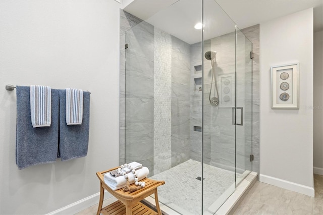 bathroom featuring a shower with door