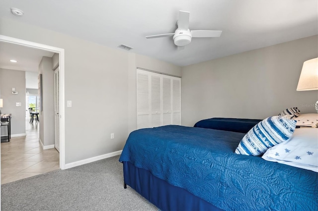 carpeted bedroom featuring a closet and ceiling fan