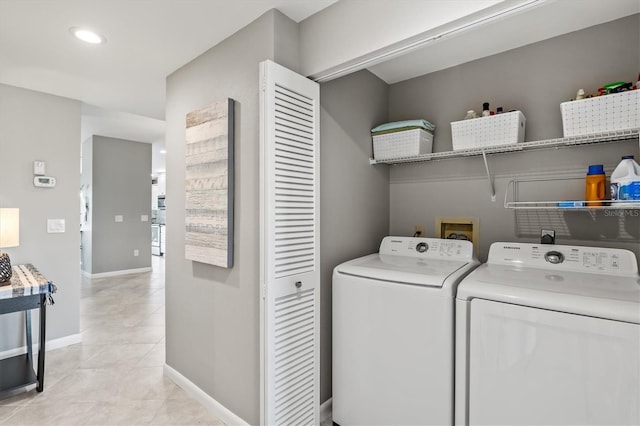 laundry room with laundry area, recessed lighting, baseboards, light tile patterned floors, and washing machine and dryer