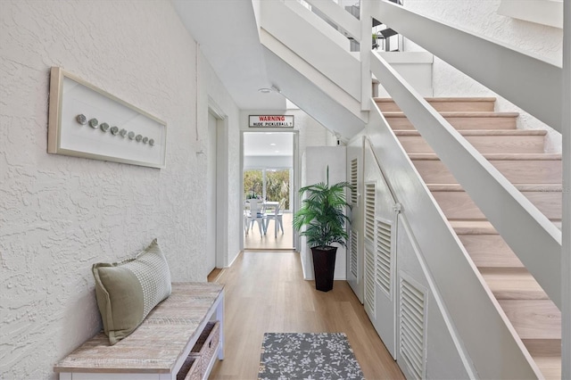 interior space featuring a textured wall and wood finished floors