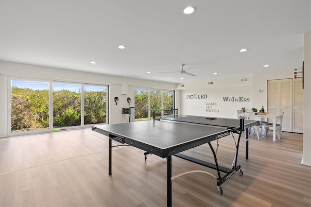 recreation room with light hardwood / wood-style flooring and ceiling fan