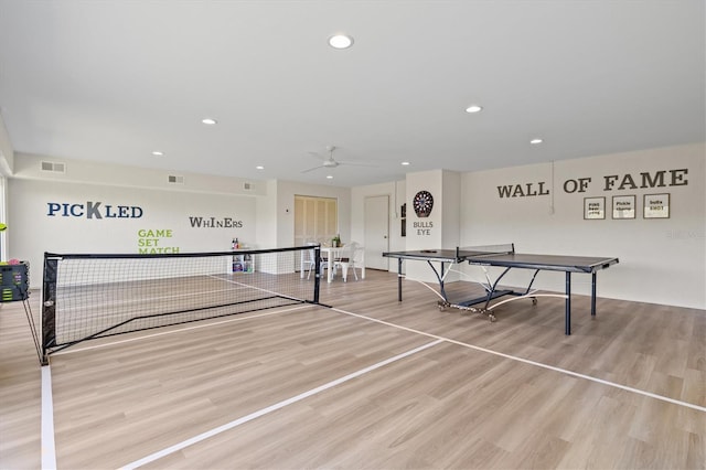 playroom with light hardwood / wood-style floors and ceiling fan