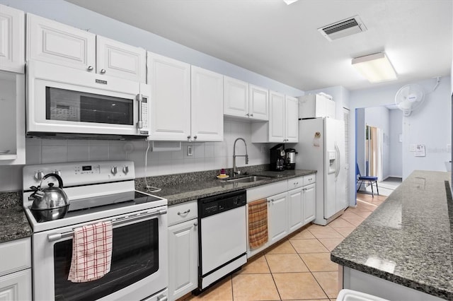 kitchen featuring white cabinetry, tasteful backsplash, sink, and white appliances