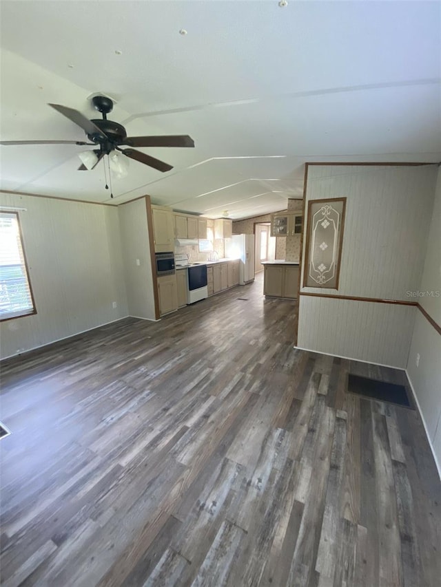 unfurnished living room featuring vaulted ceiling, ceiling fan, and dark hardwood / wood-style flooring