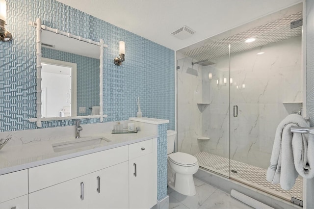 bathroom featuring toilet, vanity, and walk in shower