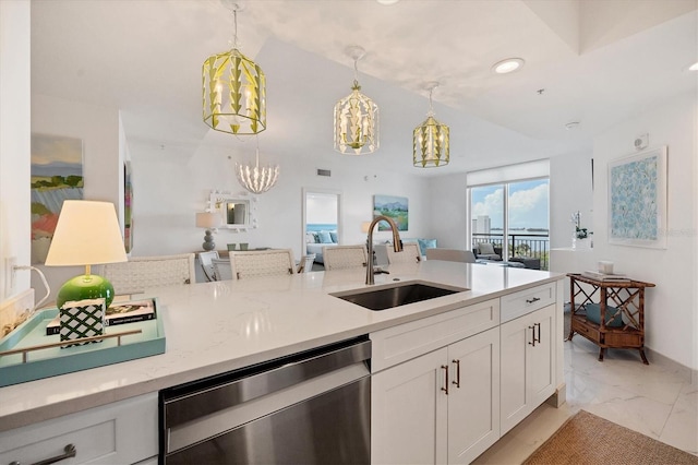 kitchen featuring sink, hanging light fixtures, stainless steel dishwasher, light stone counters, and white cabinetry