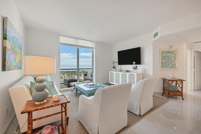 living room featuring floor to ceiling windows