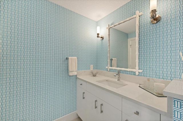 bathroom with vanity and a textured ceiling