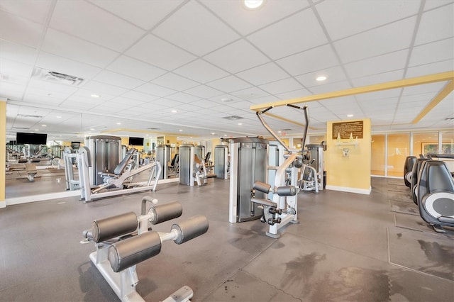 gym with a paneled ceiling