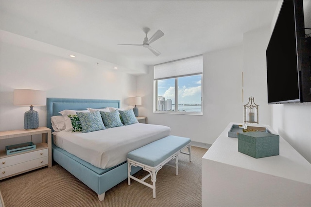 bedroom with ceiling fan and light colored carpet