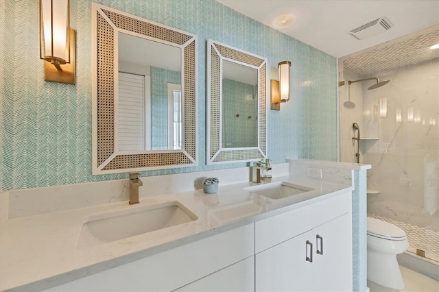 bathroom featuring vanity, toilet, and a shower with door