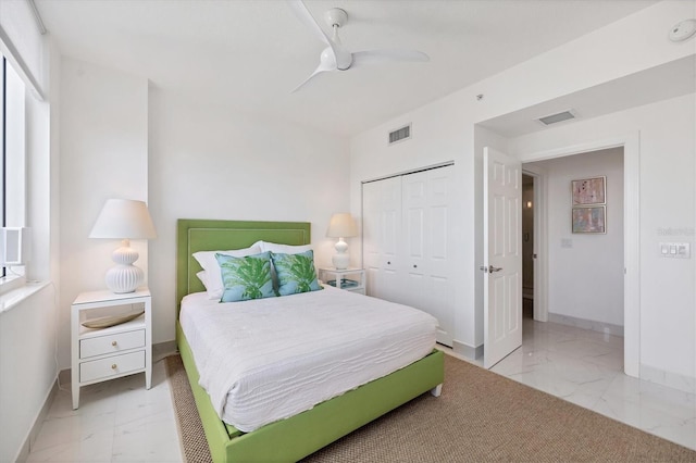 bedroom featuring multiple windows, a closet, and ceiling fan