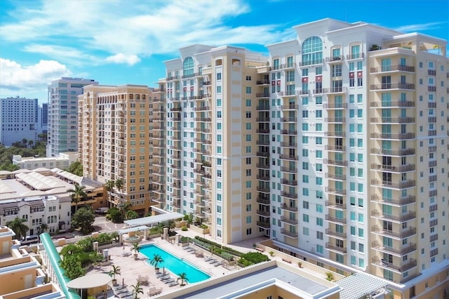 view of building exterior featuring a community pool