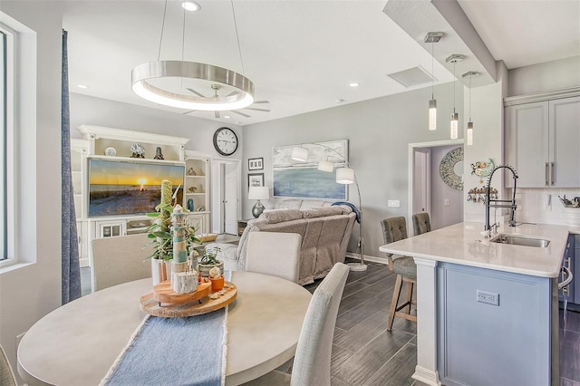 dining space featuring sink and dark hardwood / wood-style floors