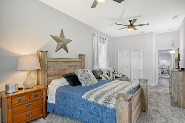 bedroom featuring light colored carpet, a closet, and ceiling fan