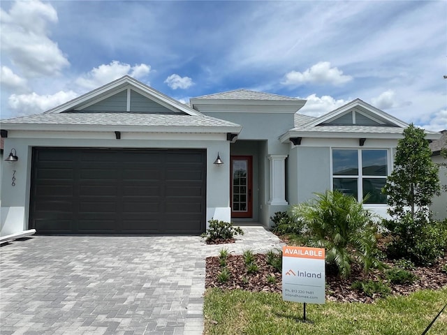 766 Hillshire Pl, Spring Hill, FL 34609 - ranch-style house featuring a garage, decorative driveway, and stucco siding
