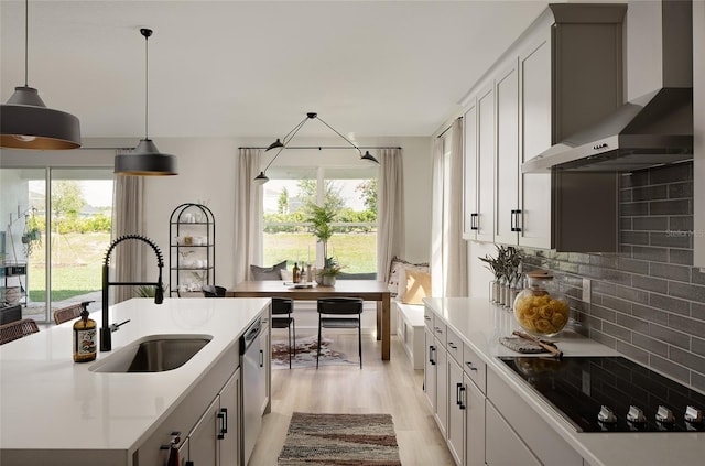 766 Hillshire Pl, Spring Hill, FL 34609 - kitchen with wall chimney range hood, black electric stovetop, stainless steel dishwasher, light wood-style floors, and backsplash
