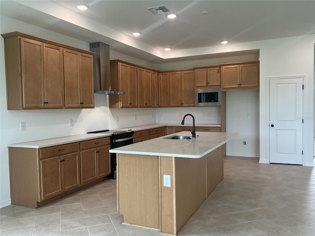 766 Hillshire Pl, Spring Hill, FL 34609 - kitchen with wall chimney range hood, electric range, stainless steel microwave, brown cabinets, and an island with sink