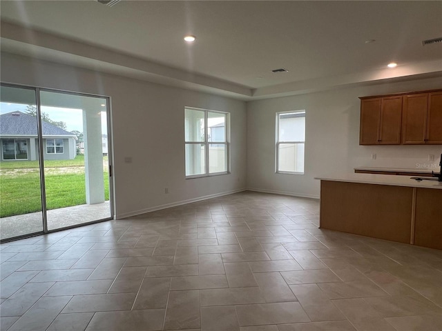 766 Hillshire Pl, Spring Hill, FL 34609 - kitchen featuring brown cabinets, recessed lighting, open floor plan, and light countertops
