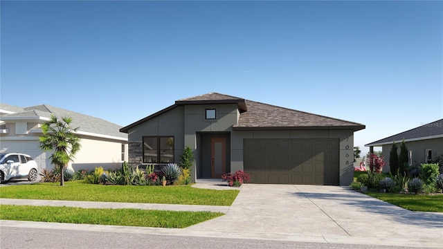 view of front of home with a garage and a front lawn