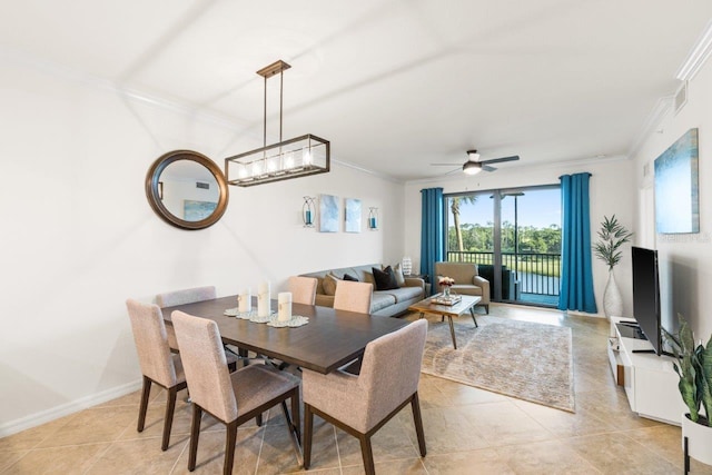 tiled dining space with crown molding and ceiling fan