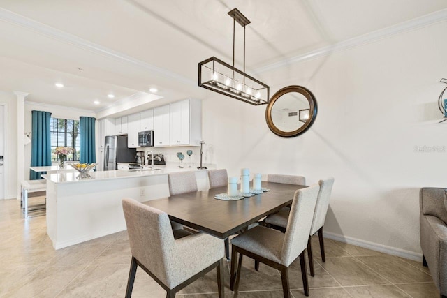 tiled dining room featuring crown molding