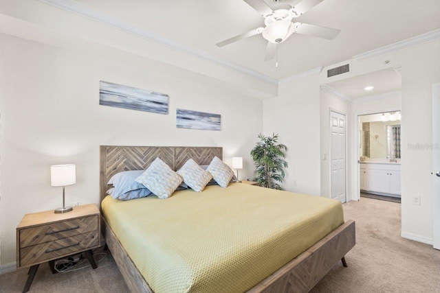 bedroom with ceiling fan, light colored carpet, connected bathroom, and crown molding