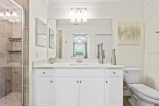 bathroom with a shower with door, vanity, and toilet