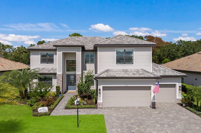 view of front facade with a front lawn and a garage