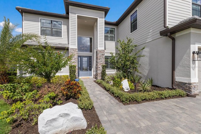16215 Tradewind Ter, Lakewood Ranch, FL 34211 - view of front facade featuring stone siding and stucco siding