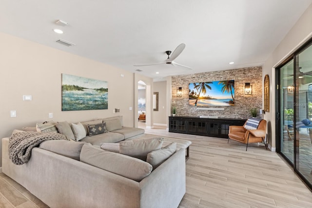 living room with light hardwood / wood-style floors and ceiling fan