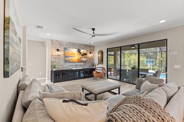 living room with light hardwood / wood-style floors and ceiling fan