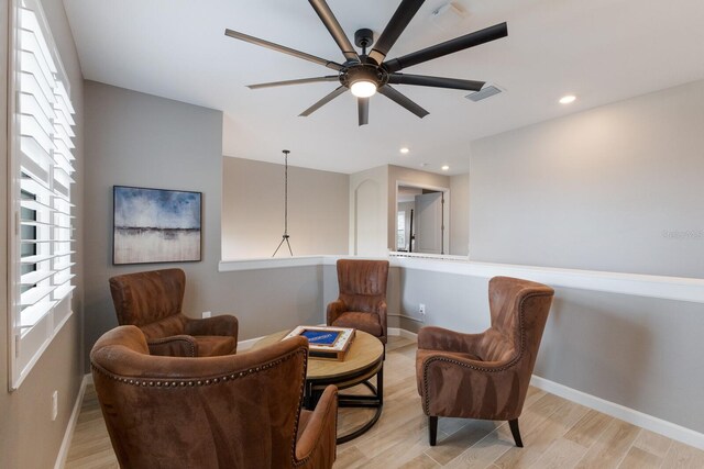 sitting room featuring light hardwood / wood-style floors and ceiling fan