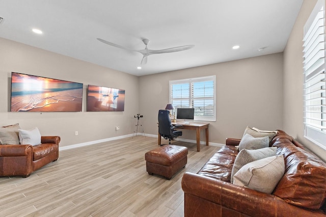 living room featuring light hardwood / wood-style floors and ceiling fan