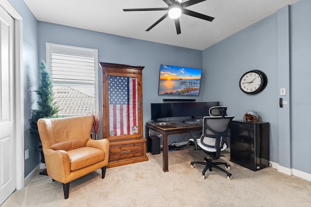 carpeted home office featuring ceiling fan